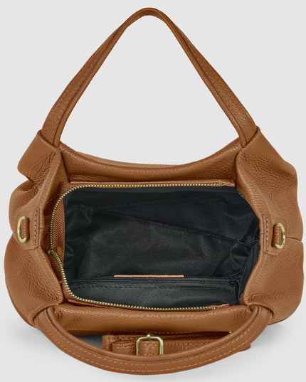 Tan Italian pebbled calfskin designer top-handle bag with gold hardware and adjustable strap.